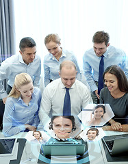 Image showing smiling business people with laptop in office