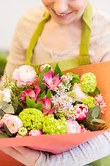 Image showing close up of woman with bunch at flower shop