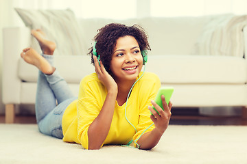 Image showing happy african woman with smartphone and headphones