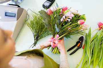 Image showing close up of woman making bunch at flower shop