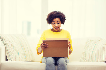 Image showing happy african young woman with parcel box at home