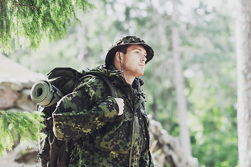 Image showing young soldier with backpack in forest