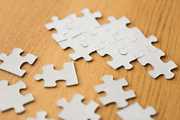 Image showing close up of puzzle pieces on wooden surface