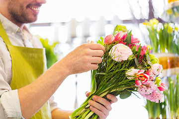 Image showing close up of florist man with bunch at flower shop