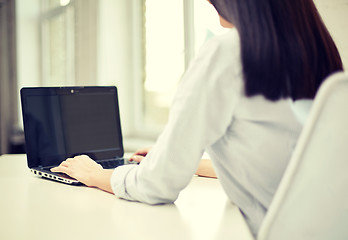 Image showing close up of woman typing on laptop at office
