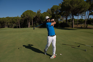 Image showing golf player hitting shot