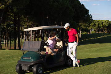 Image showing couple in buggy on golf course