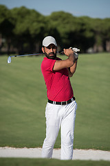 Image showing golfer hitting a sand bunker shot