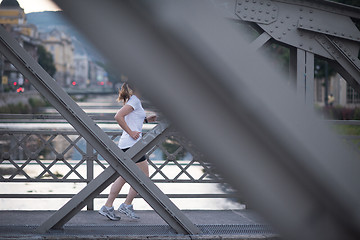 Image showing sporty woman running  on sidewalk