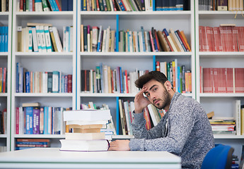 Image showing portrait of student while reading book  in school library