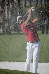 Image showing golfer hitting a sand bunker shot