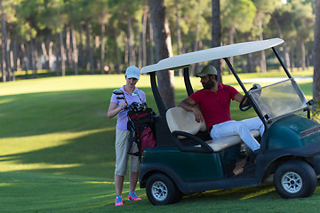 Image showing couple in buggy on golf course