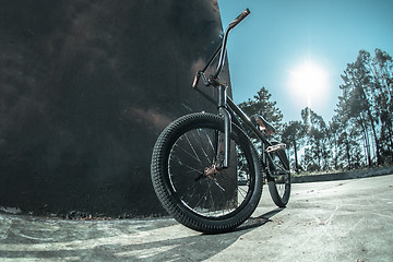 Image showing Bmx bike standing against black  wall