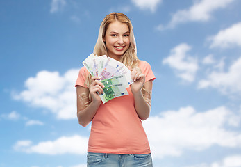 Image showing happy young woman with euro cash money