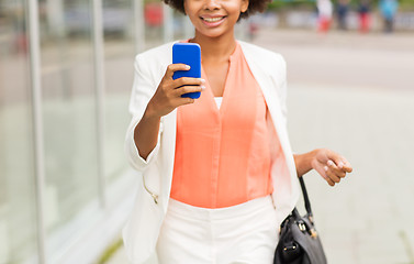 Image showing close up of african woman with smartphone in city