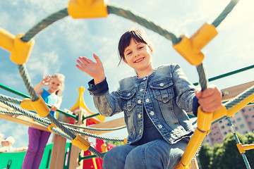 Image showing happy little girl climbing on children playground