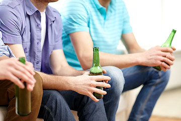 Image showing happy male friends drinking beer at home