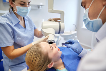 Image showing dentists and patient with dental x-ray machine