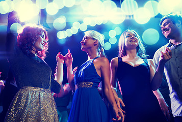 Image showing smiling friends dancing in club