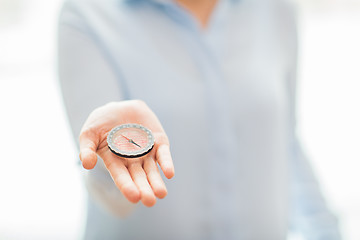 Image showing close up of woman hand holding compass