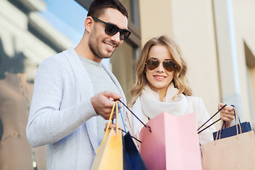 Image showing happy couple with shopping bags on city street