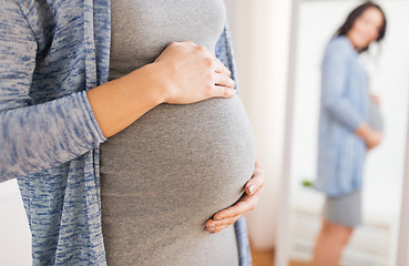 Image showing close up of pregnant woman looking to mirror