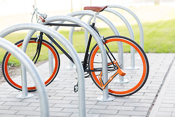 Image showing close up of bicycle locked at street parking