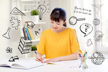 Image showing happy asian young woman student learning at home