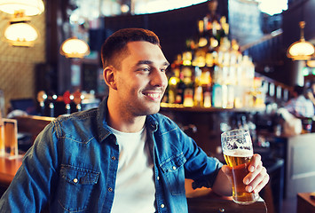 Image showing happy man drinking beer at bar or pub