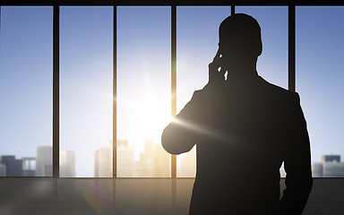 Image showing silhouette of business man calling on smartphone