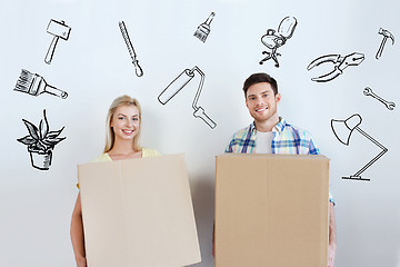 Image showing smiling couple with big boxes moving to new home