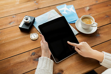 Image showing close up of traveler hands with tablet pc and map