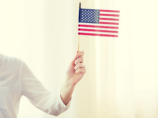 Image showing close up of woman holding american flag in hand