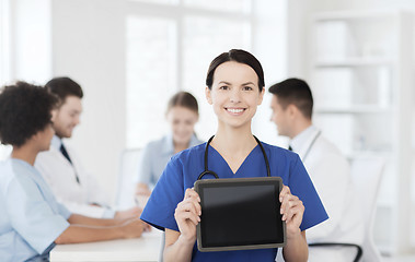 Image showing happy doctor over group of medics at hospital