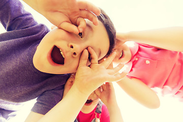 Image showing group of kids having fun and making faces outdoors