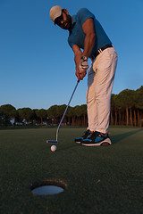 Image showing golfer  hitting shot at golf course