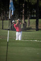 Image showing golfer hitting a sand bunker shot