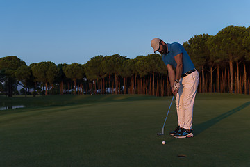 Image showing golfer  hitting shot at golf course