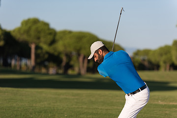 Image showing pro golfer hitting a sand bunker shot