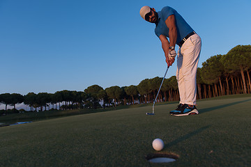 Image showing golfer  hitting shot at golf course