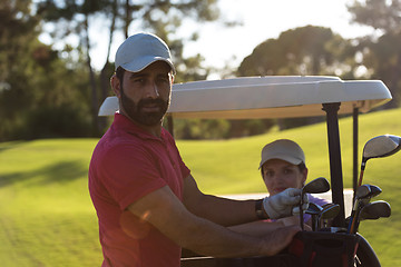 Image showing couple in buggy on golf course