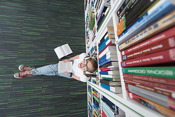 Image showing female student study in library, using tablet and searching for 