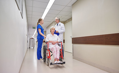 Image showing medics and senior woman in wheelchair at hospital