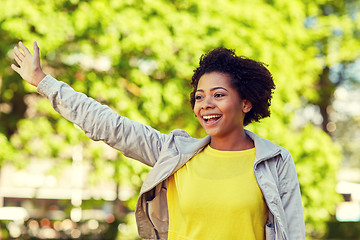 Image showing happy african american young woman in summer park