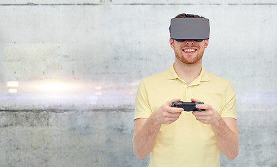 Image showing man in virtual reality headset and gamepad playing