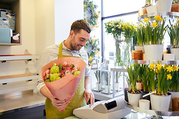 Image showing florist man or seller at flower shop cashbox