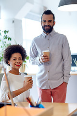 Image showing happy man and woman drinking coffee in office