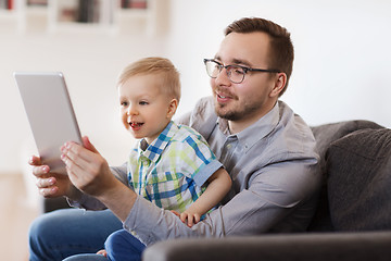 Image showing father and son with tablet pc playing at home