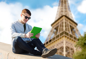 Image showing happy young man with tablet pc over eiffel tower