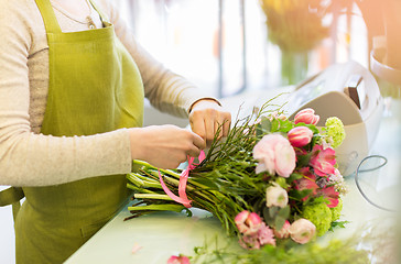 Image showing close up of woman making bunch at flower shop